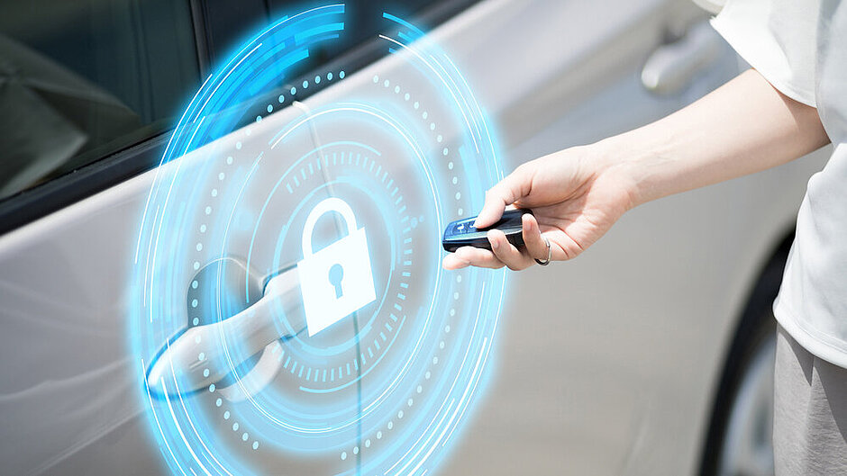 Woman with car keys in front of a car door with an illustrated lock in front, symbolizing security.