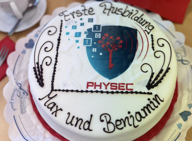 Kuchen mit dem PHYSEC Logo und "Erste Ausbildung Max und Benjamin"